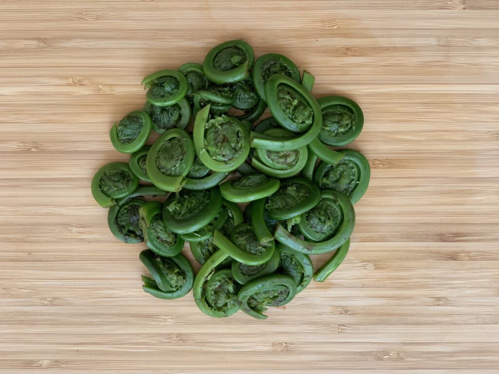 Fiddleheads cleaned & trimmed on a cutting board