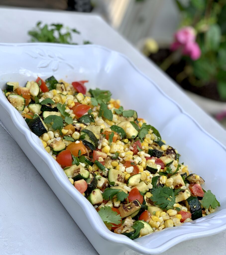 Grilled corn & Zucchini Salad prepared in a white rectangular serving dish