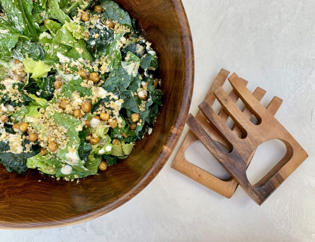 Vegan Caesar Salad with serving spoons on side