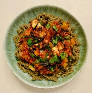 Veggie Tempeh Bolognese over mung bean pasta and topped with fresh basil.
