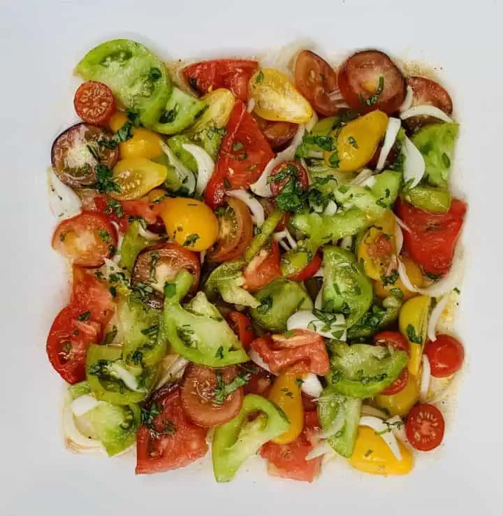 Assorted garden tomatoes mixed together in a salad and plated