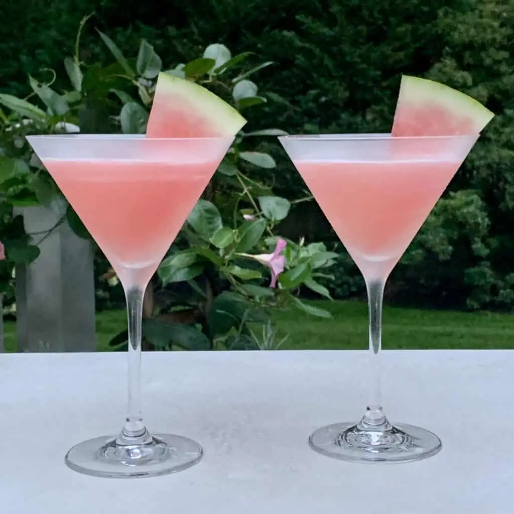 2 watermelon cosmo drinks with watermelon wedges
