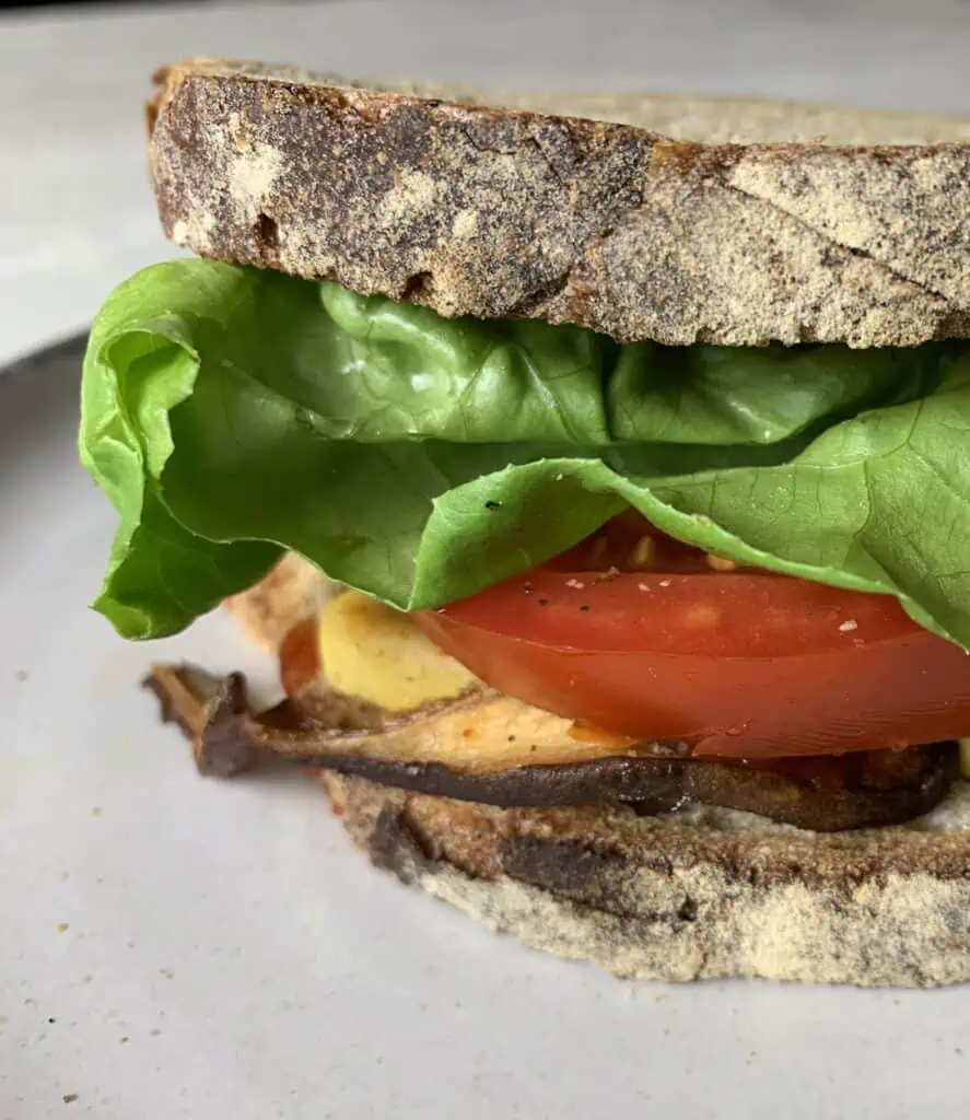 Vegan Shiitake BLT Sandwich with Almond Cheddar Cheese close up