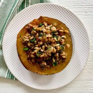 Stuffed acorn squash on a plate.