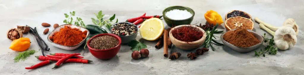 Spices and herbs on table.