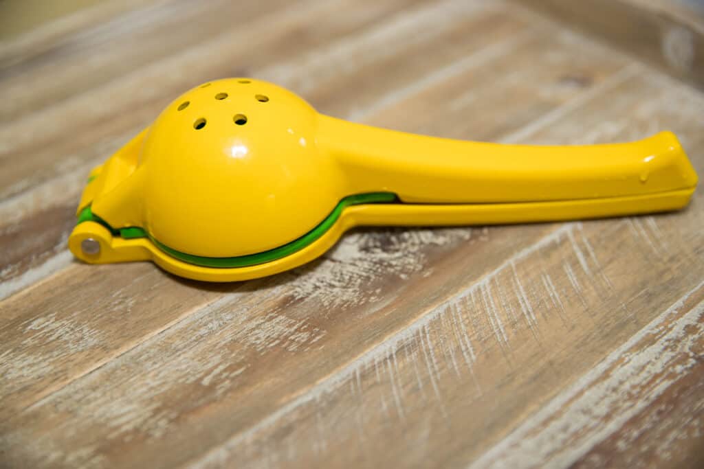Lemon Squeezer on wooden background.