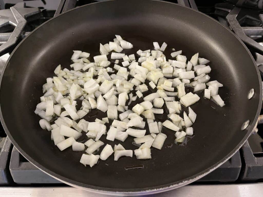 Onions in cooking in pan with oil