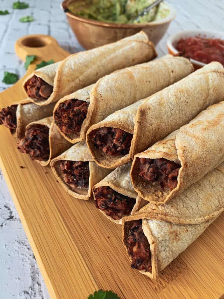 taquitos piled on a cutting board