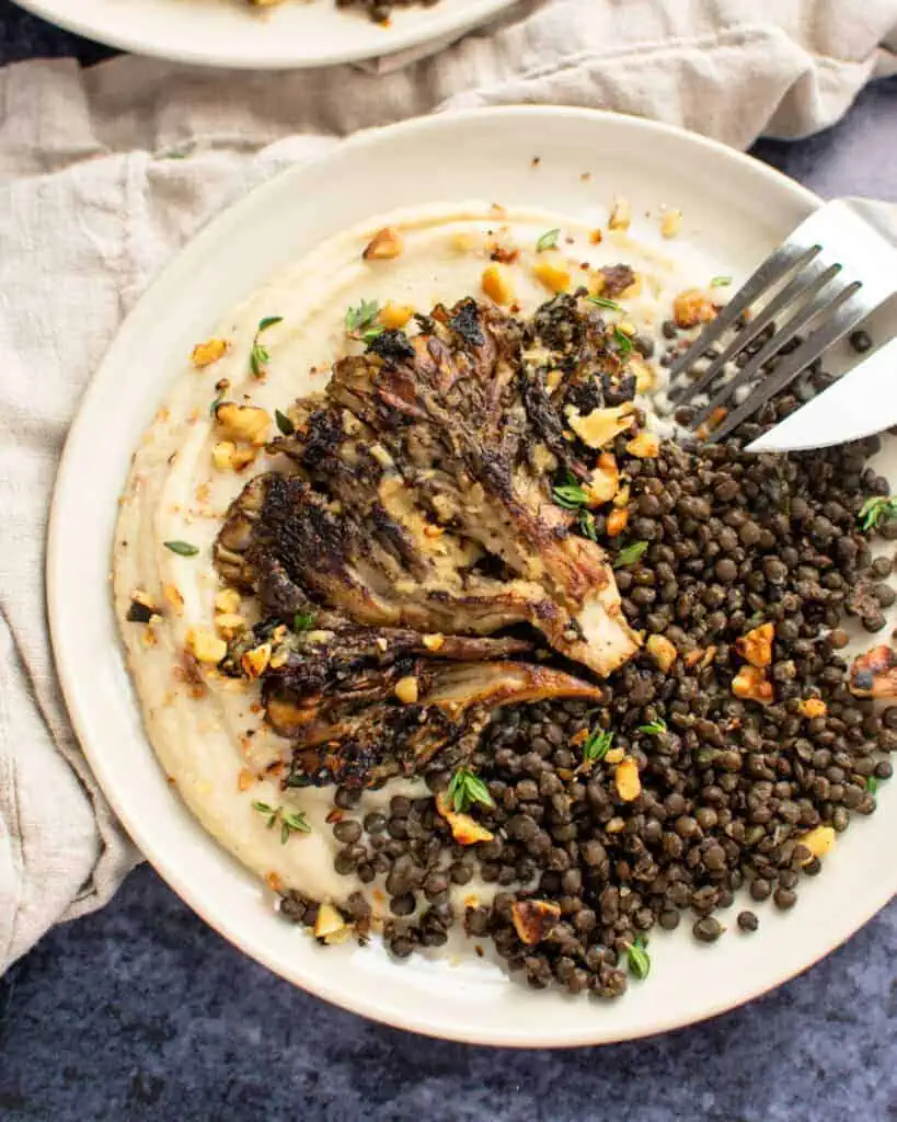 Seared mushroom on a bed of lentils.